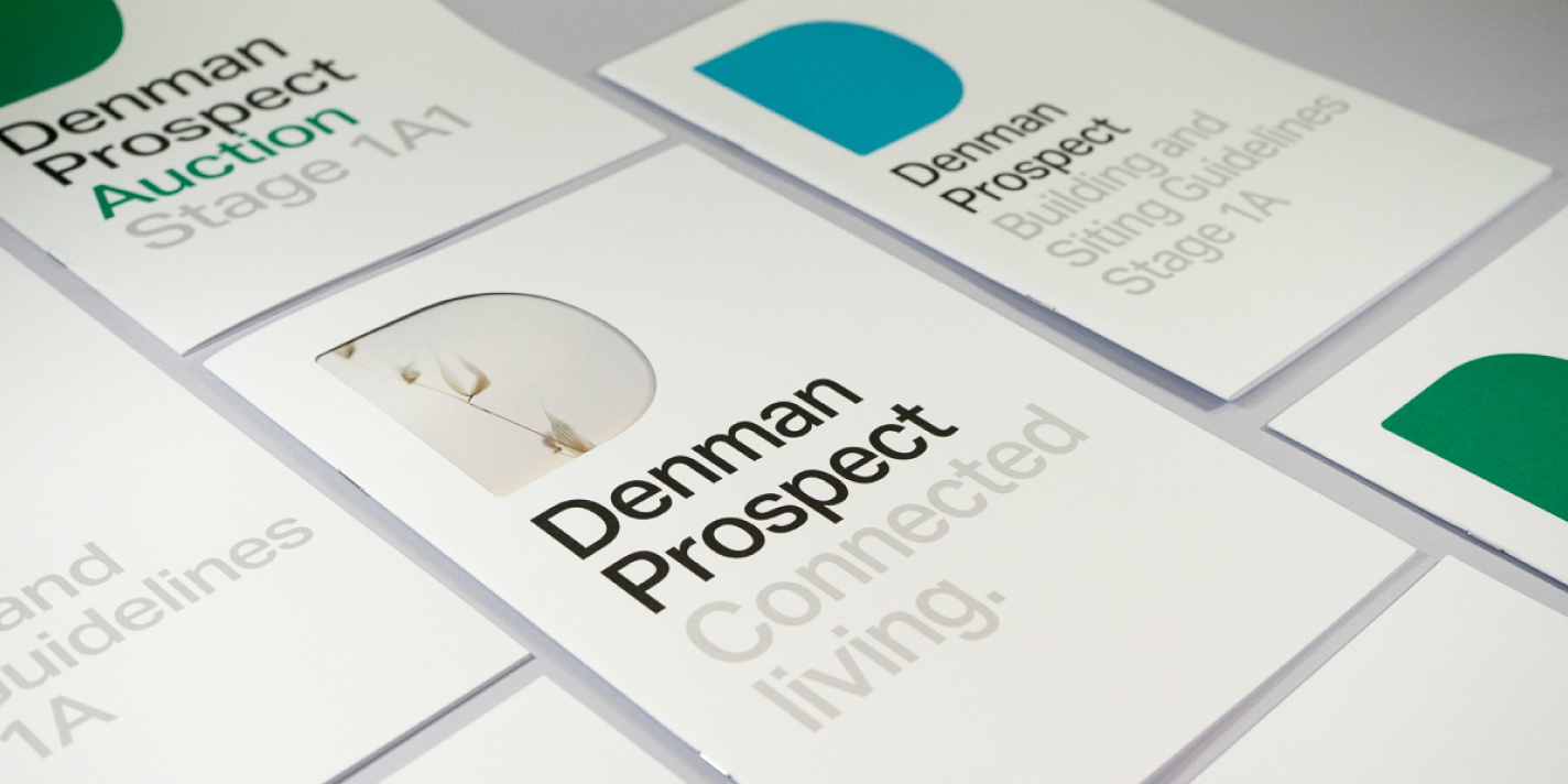 Denman Prospect brochures laid out on a grey background.